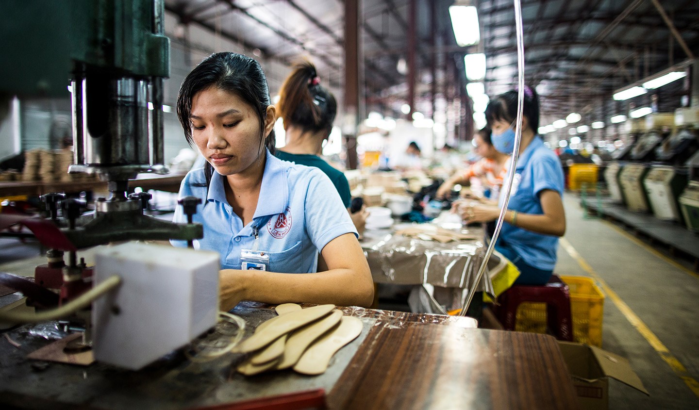 A young female factory worker assembles shoes at the Lien Phat factory in Binh Duong province, Vietnam.